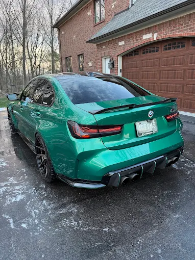 Green BMW M3 with a deep gloss finish after waxing